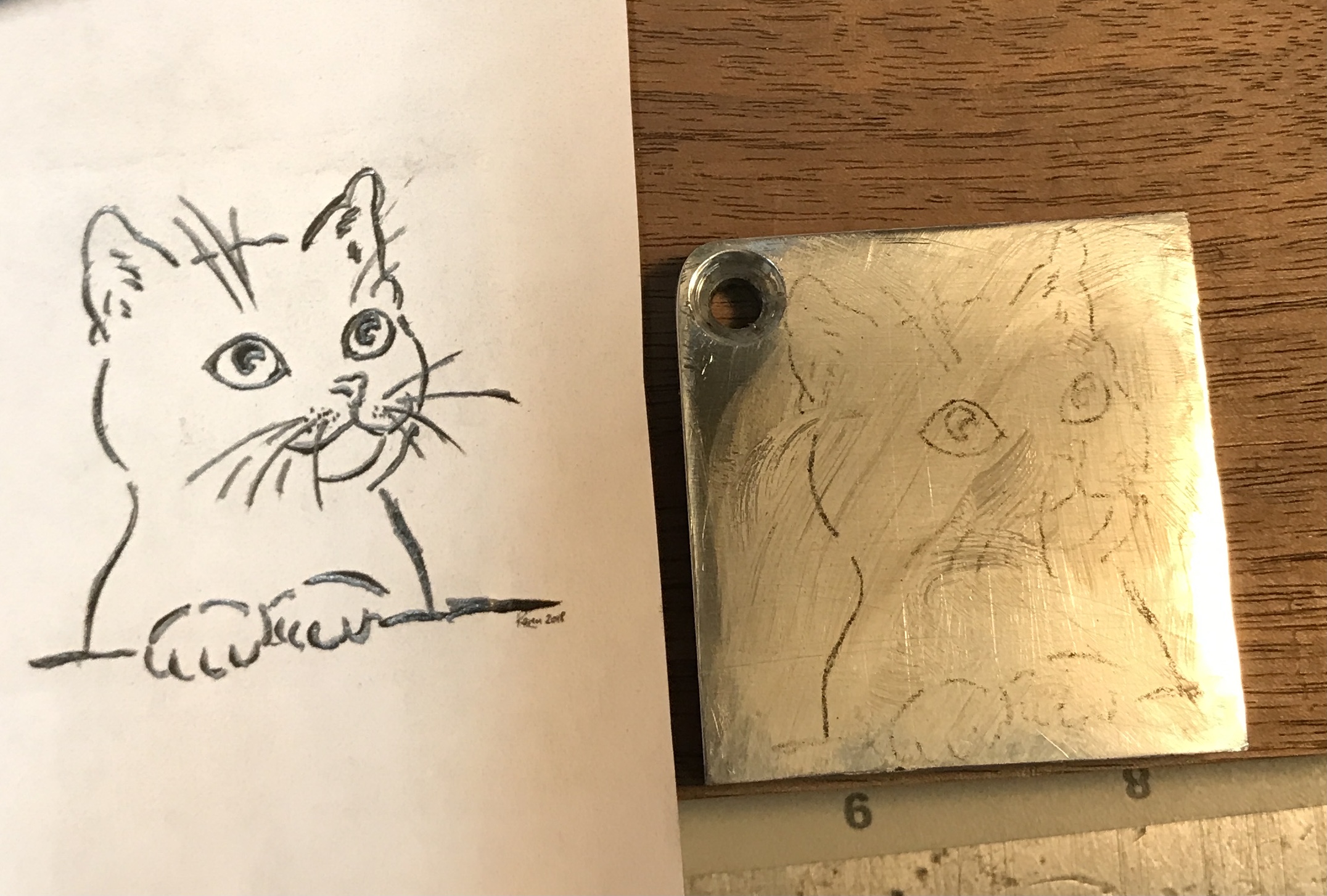 The printed cat sketch and the transfered version.